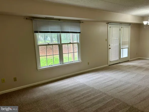 an empty room with a empty space and windows
