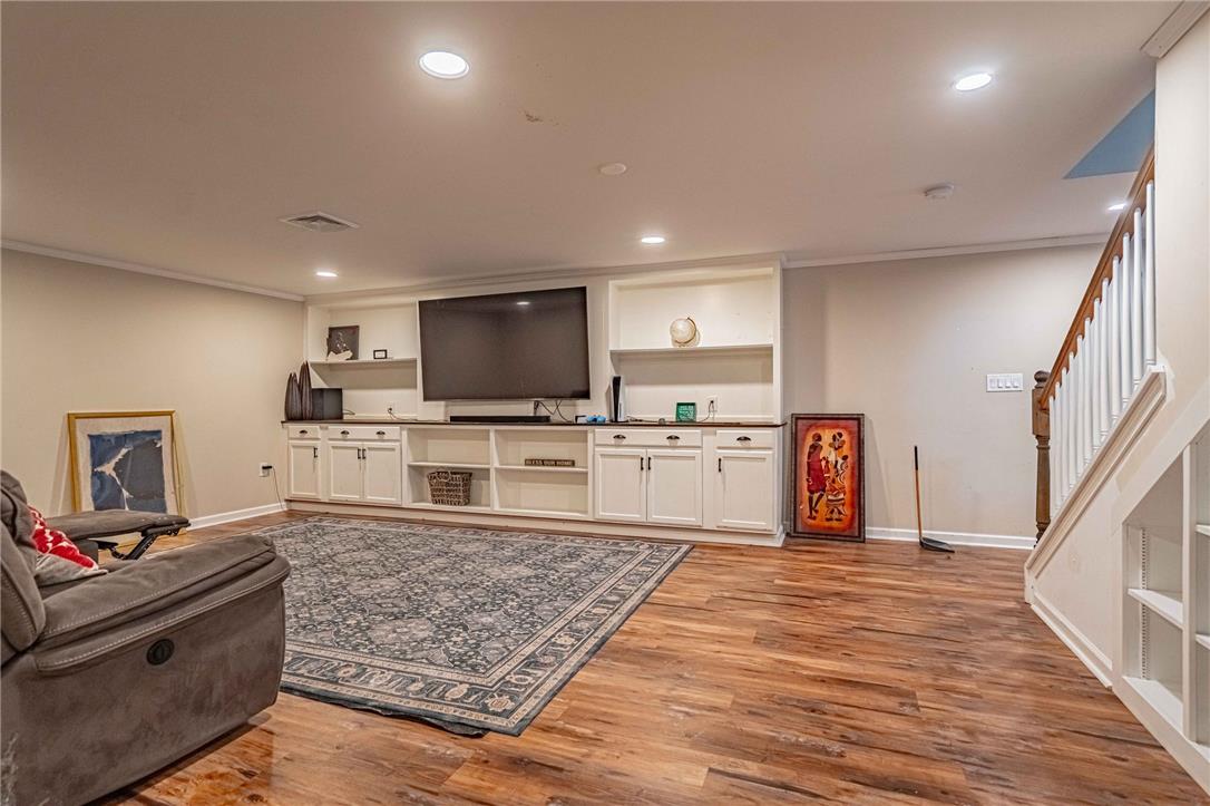 102 Sutton Road Easton, PA 18045 - Photo 54 of 83 Gleaming hardwood floors and a sprawling built-in media console define this versatile lower level living area.