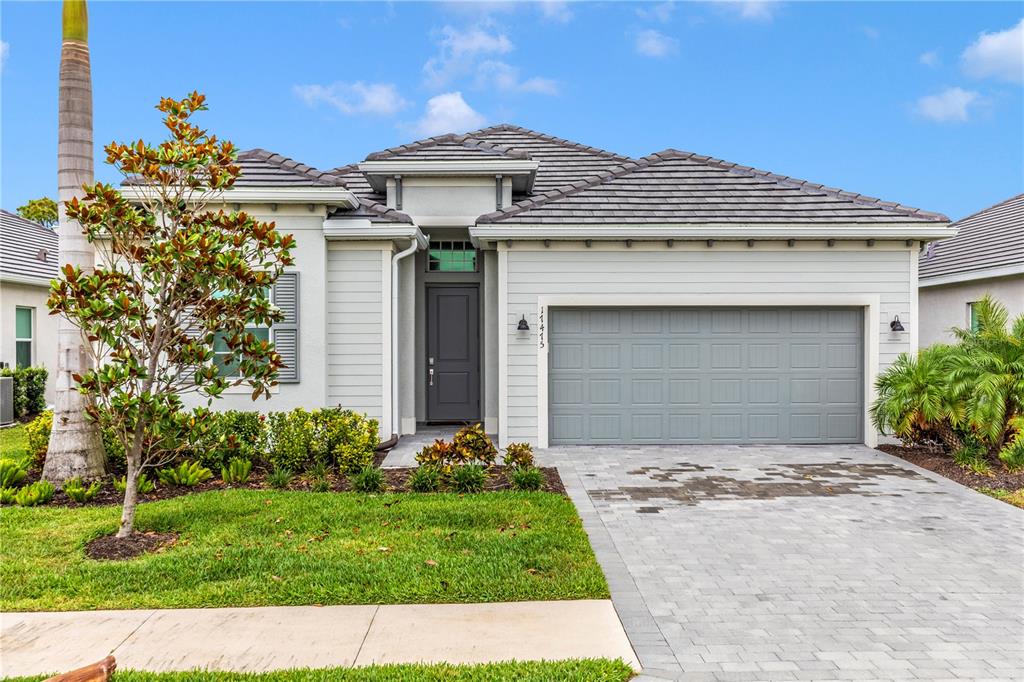 a front view of a house with a garden