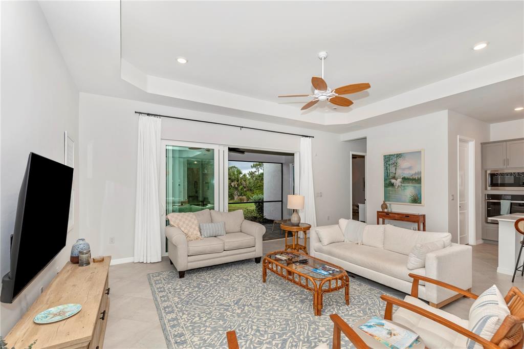 17475 Jadestone Court Venice, FL 34293 - Photo 16 of 100 a living room with furniture and a flat screen tv