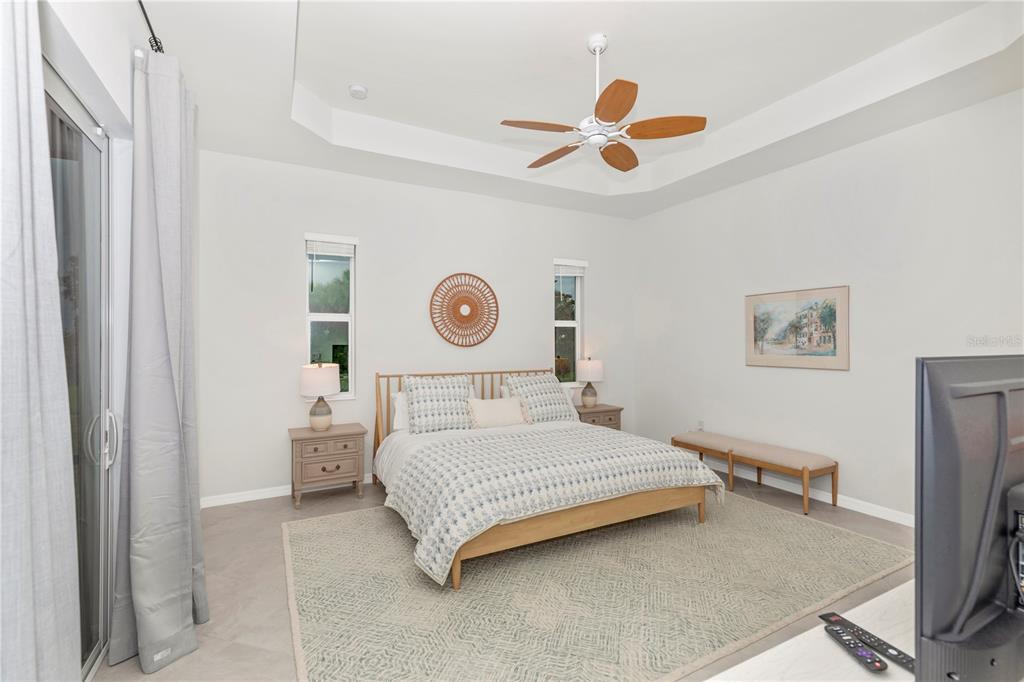 17475 Jadestone Court Venice, FL 34293 - Photo 20 of 100 a bedroom with a bed and a chandelier