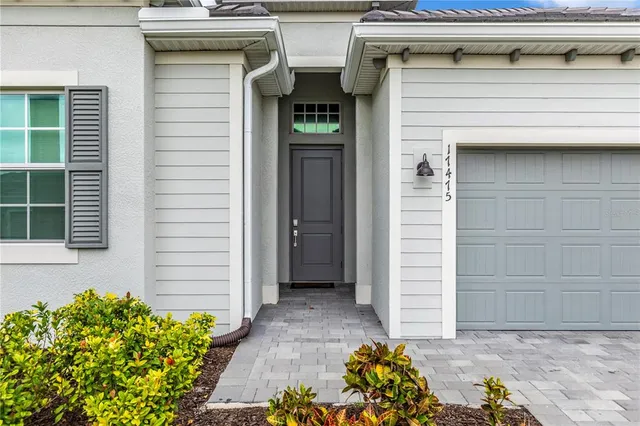 a kitchen with refrigerator and chairs