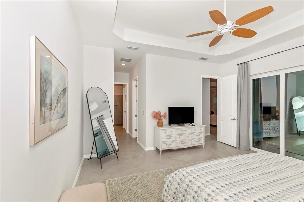 17475 Jadestone Court Venice, FL 34293 - Photo 22 of 100 a bedroom with a bed and a flat screen tv