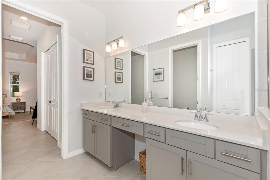 17475 Jadestone Court Venice, FL 34293 - Photo 26 of 100 a bathroom with a sink and a mirror