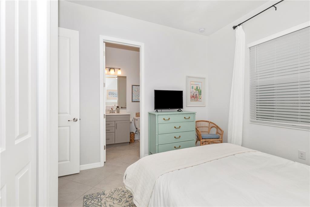 17475 Jadestone Court Venice, FL 34293 - Photo 29 of 100 a bedroom with a bed and a flat screen tv