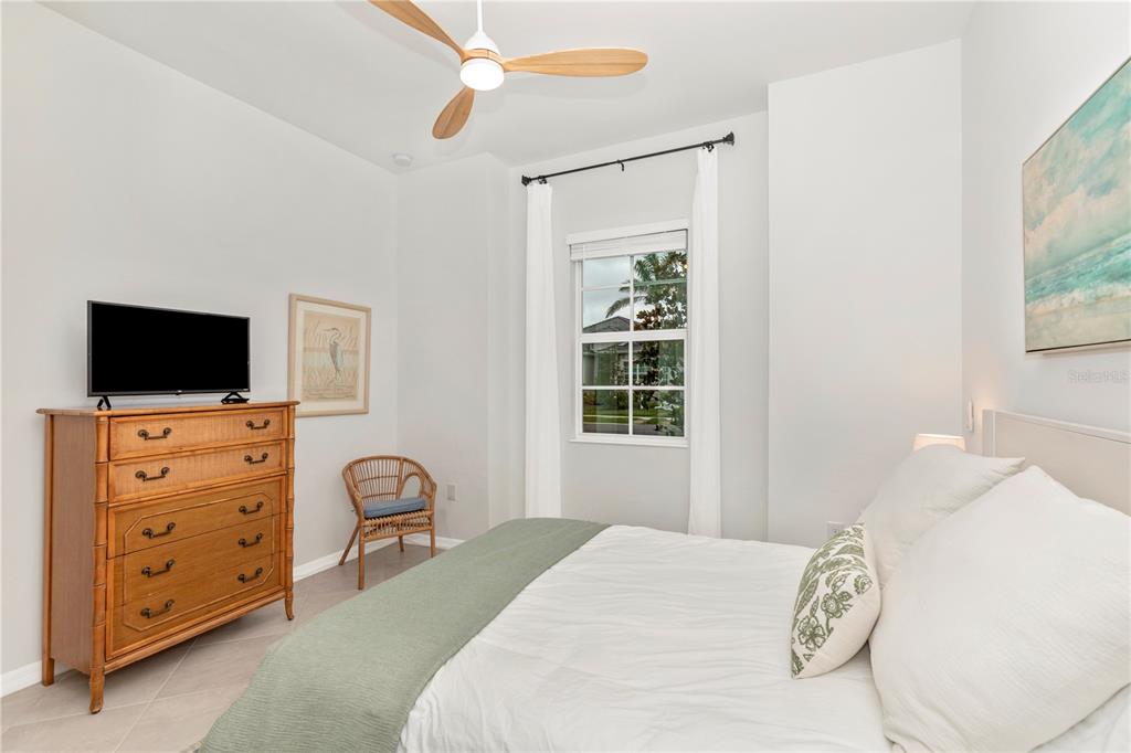 17475 Jadestone Court Venice, FL 34293 - Photo 33 of 100 a bedroom with a bed and a flat screen tv