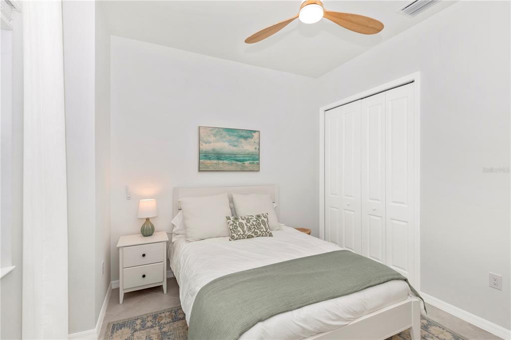 17475 Jadestone Court Venice, FL 34293 - Photo 34 of 100 a bedroom with a bed and a painting on the wall