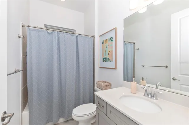 a front view of a house with glass windows and furniture