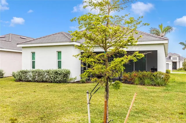 a view of a house with backyard porch and sitting area
