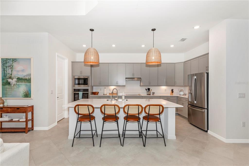 17475 Jadestone Court Venice, FL 34293 - Photo 5 of 100 a kitchen with refrigerator and chairs