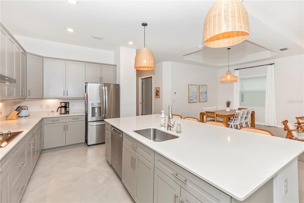 17475 Jadestone Court Venice, FL 34293 - Photo 7 of 100 a kitchen with stainless steel appliances a sink a refrigerator and a stove