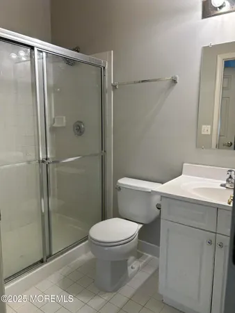 a white toilet sitting next to a bathroom sink