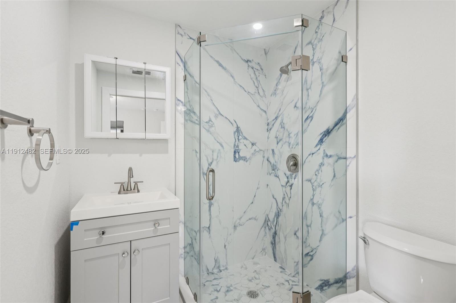 17003 Southwest 107th Place, Unit 2 Miami, FL 33157 - Photo 12 of 16 a bathroom with a shower and a sink