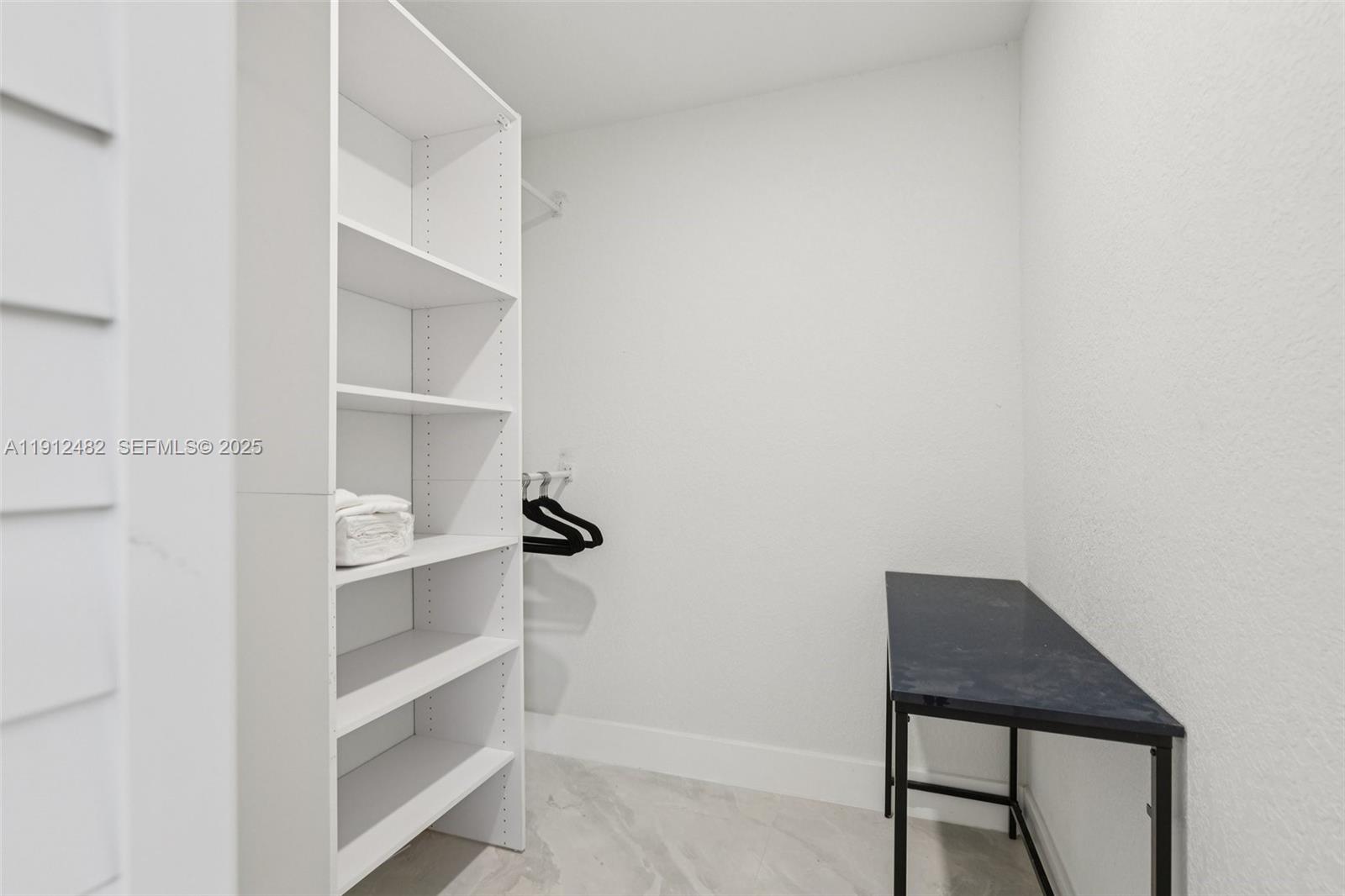 17003 Southwest 107th Place, Unit 2 Miami, FL 33157 - Photo 13 of 16 a view of a room with rack on the wall