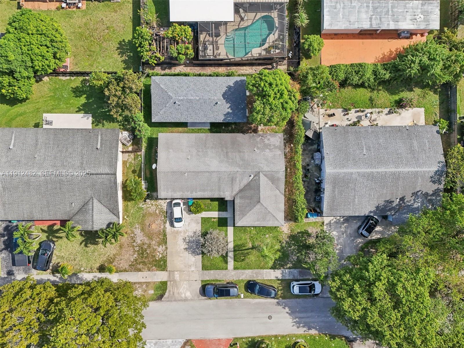 17003 Southwest 107th Place, Unit 2 Miami, FL 33157 - Photo 14 of 16 an aerial view of a house with a yard and potted plants