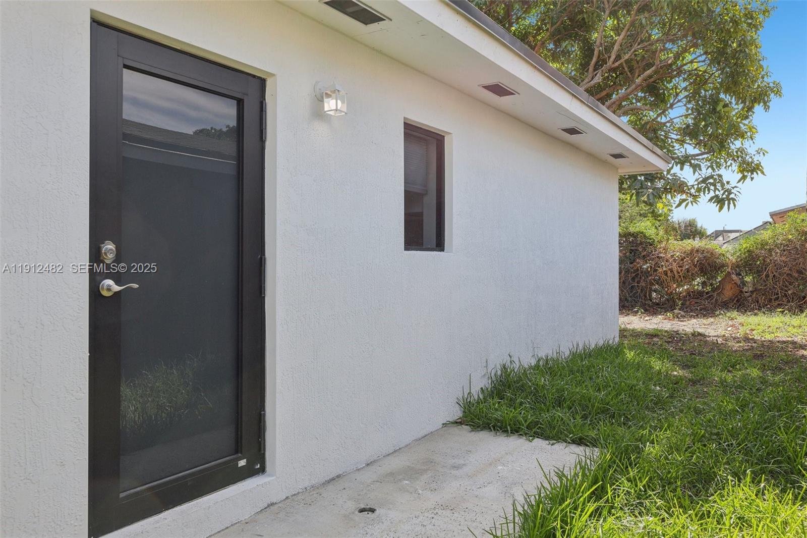 17003 Southwest 107th Place, Unit 2 Miami, FL 33157 - Photo 3 of 16 a backyard of a house with lots of green space