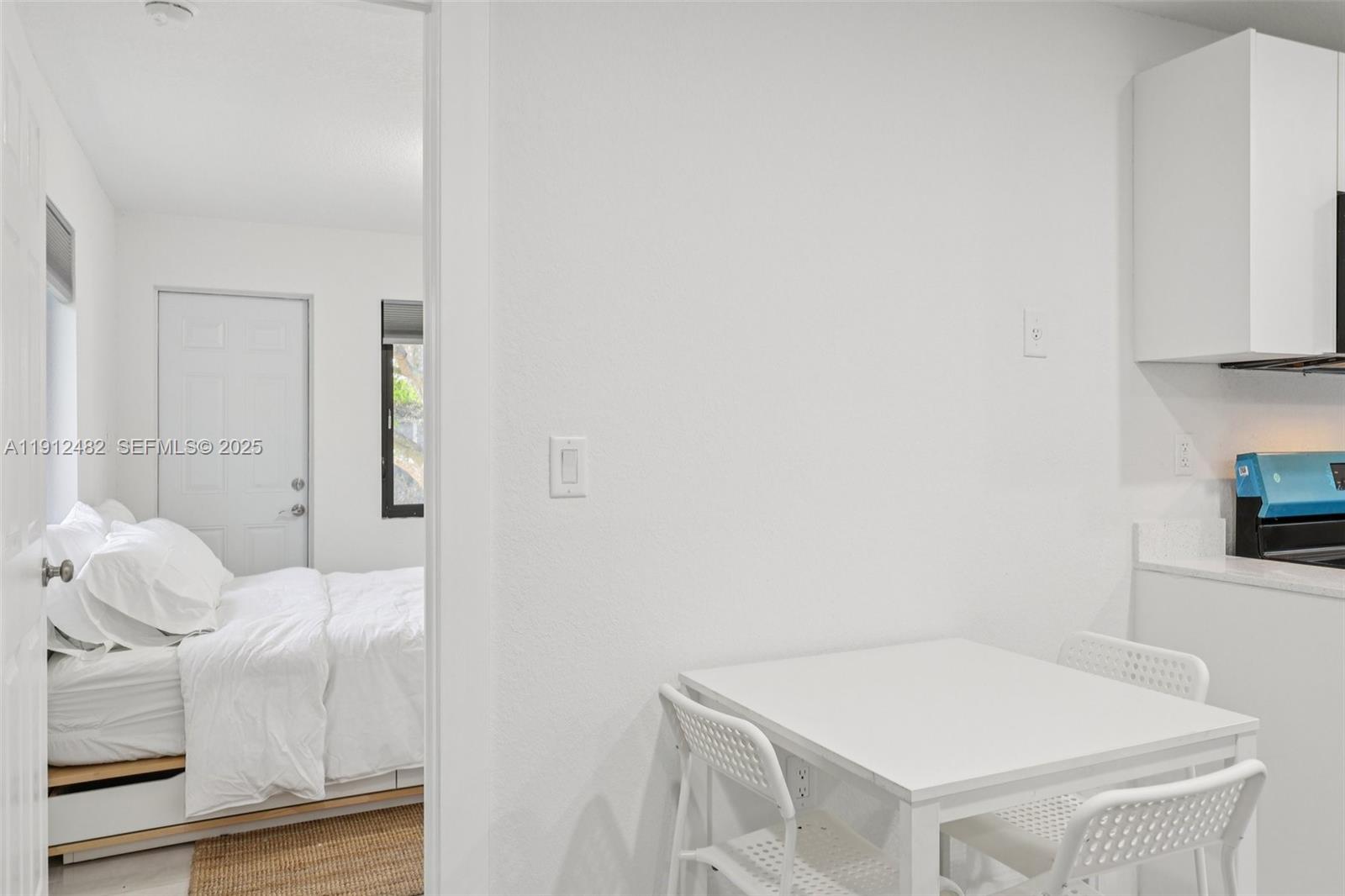 17003 Southwest 107th Place, Unit 2 Miami, FL 33157 - Photo 9 of 16 a bedroom with a bed and a white wall