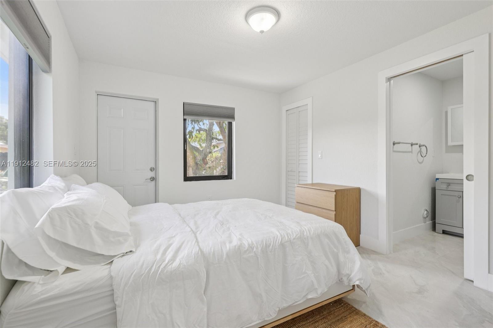 17003 Southwest 107th Place, Unit 2 Miami, FL 33157 - Photo 10 of 16 a bedroom with a bed and a window