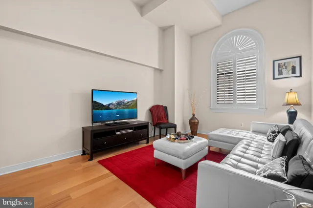 a living room with furniture rug and a window