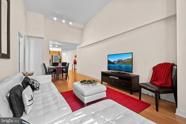 a kitchen with stainless steel appliances granite countertop a dining table and a refrigerator