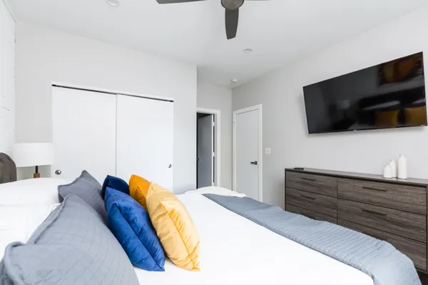 a bedroom with a bed and wooden floor