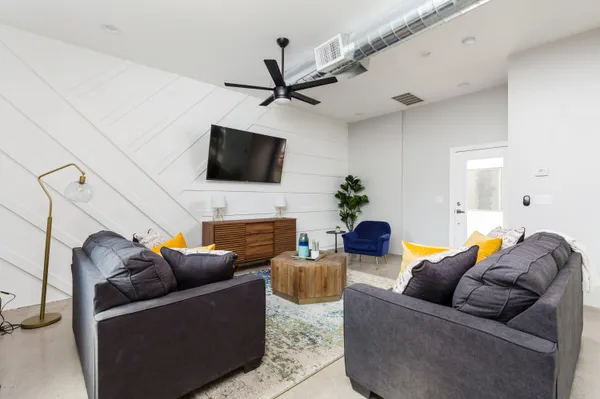 a living room with furniture and a flat screen tv