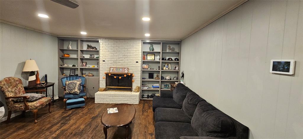6766 Broadacres Road Shreveport, LA 71129 - Photo 2 of 20 a living room with furniture and a fireplace