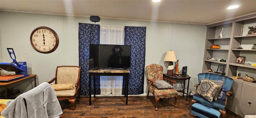 6766 Broadacres Road Shreveport, LA 71129 - Photo 3 of 20 a living room with furniture a flat screen tv and a fireplace