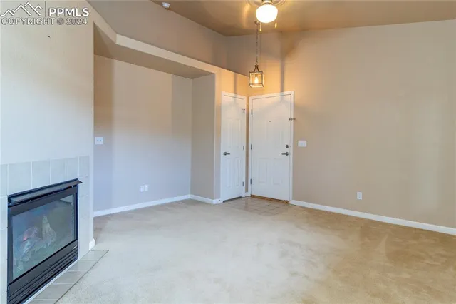 a view of an empty room with a fireplace