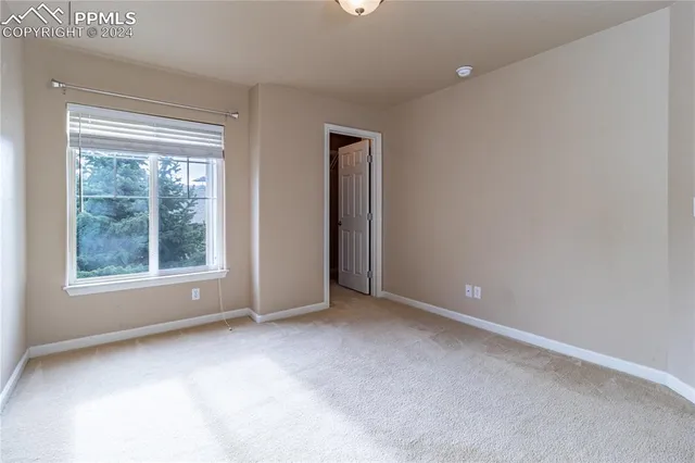 an empty room with windows and closet