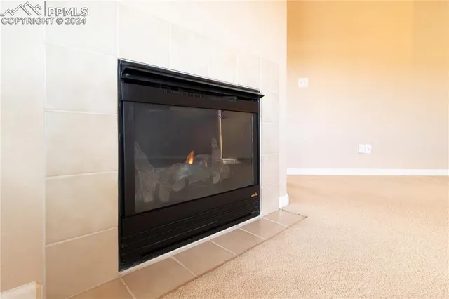 a living room with a door and a picture of door