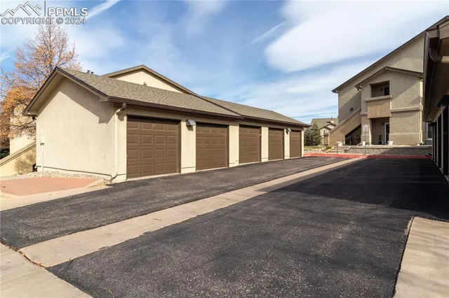 a front view of a house with a road