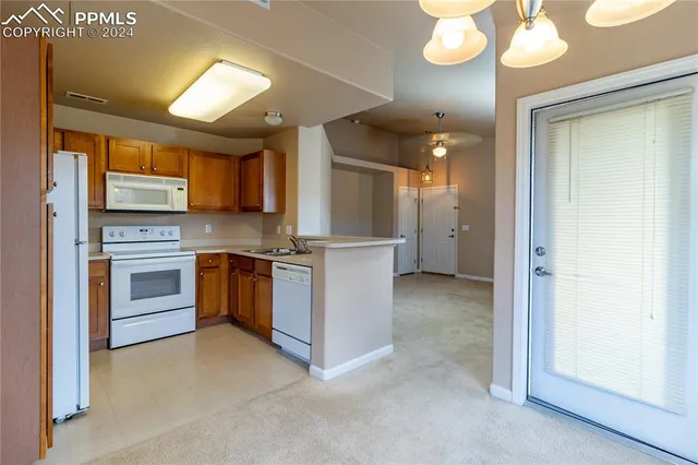 a view of kitchen with granite countertop cabinets and stainless steel appliances