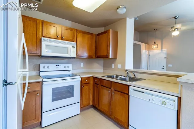 a kitchen with stainless steel appliances granite countertop a sink stove and microwave