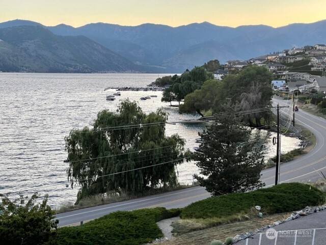 304 Highway 150, Unit 1A Chelan, WA 98816 - Photo 16 of 25 a view of a house with a yard and a wooden fence