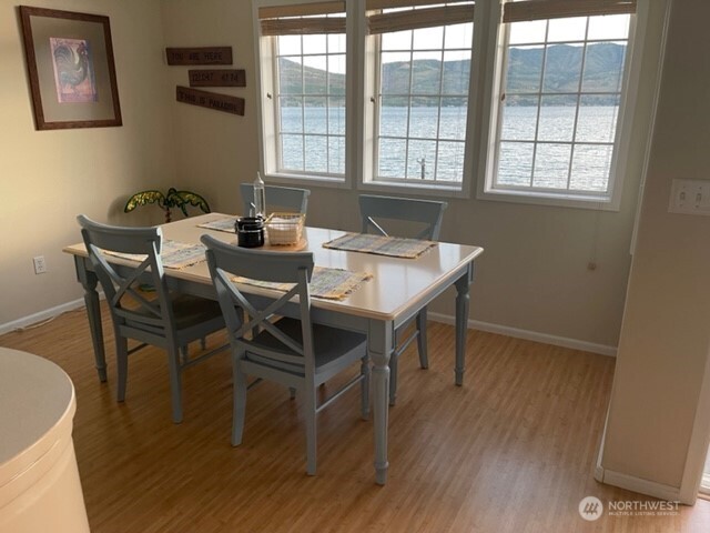 304 Highway 150, Unit 1A Chelan, WA 98816 - Photo 8 of 25 a view of a dining room with furniture and wooden floor