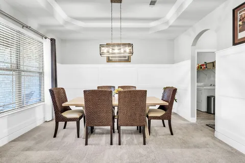 a kitchen with stainless steel appliances granite countertop a stove a sink and a wooden cabinets