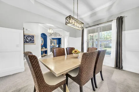 a large kitchen with granite countertop a large kitchen island a sink stainless steel appliances and cabinets