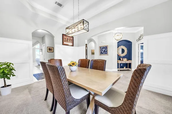 a kitchen with stainless steel appliances granite countertop a stove a sink and a wooden cabinets