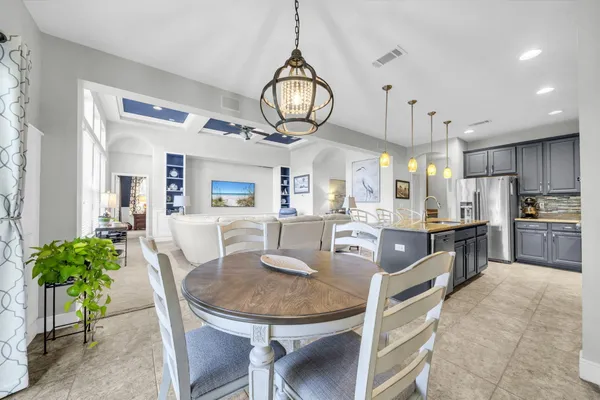 a living room with furniture ceiling fan and a rug
