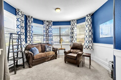 a bedroom with a bed and a painting on the wall