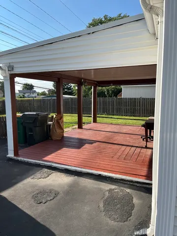 a backyard of a house with barbeque oven table and chairs