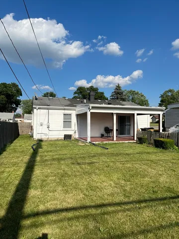 a view of a yard in front of a house with a garden