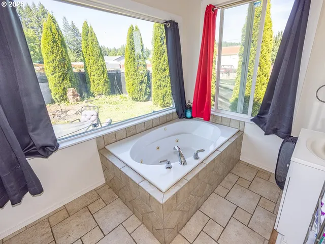 a living room with large window and a table