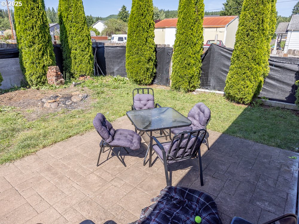 410 East Yacolt Road Yacolt, WA 98675 - Photo 30 of 39 a view of a chairs and table in backyard