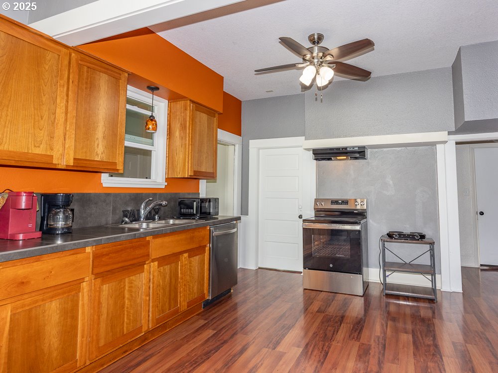 410 East Yacolt Road Yacolt, WA 98675 - Photo 33 of 39 a kitchen with stainless steel appliances a sink cabinets and wooden floor