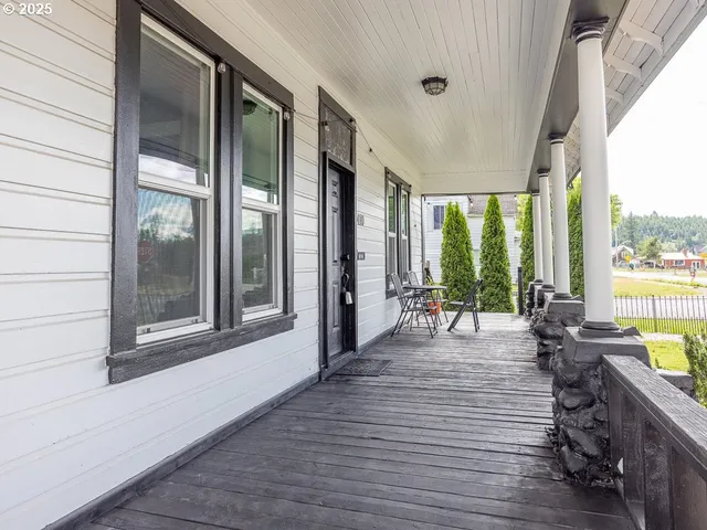 a living room with furniture and large windows