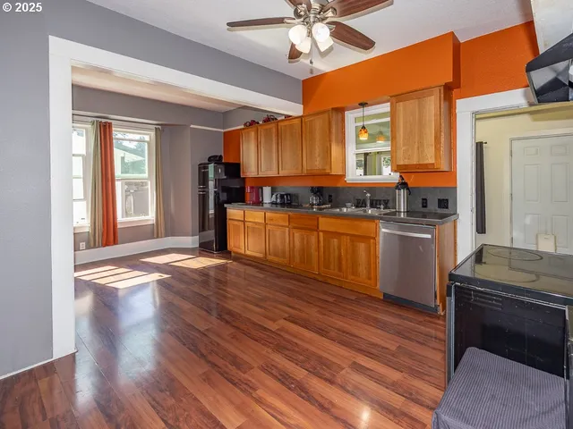 a kitchen with stainless steel appliances granite countertop a stove and cabinets