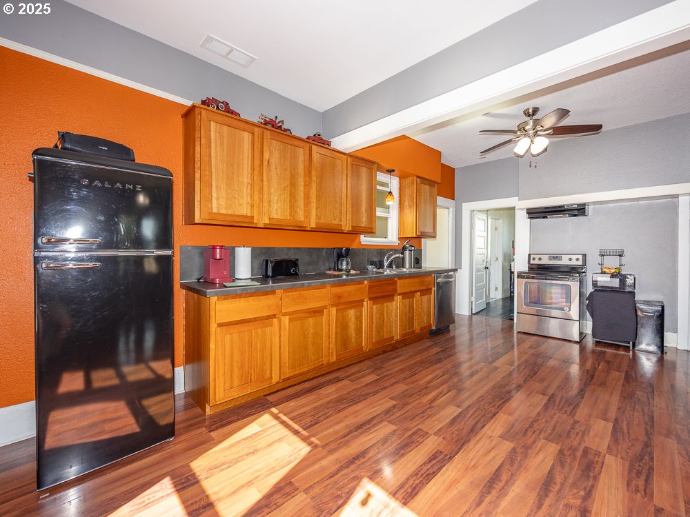 410 East Yacolt Road Yacolt, WA 98675 - Photo 9 of 39 a kitchen with granite countertop a refrigerator a stove top oven and wooden floors