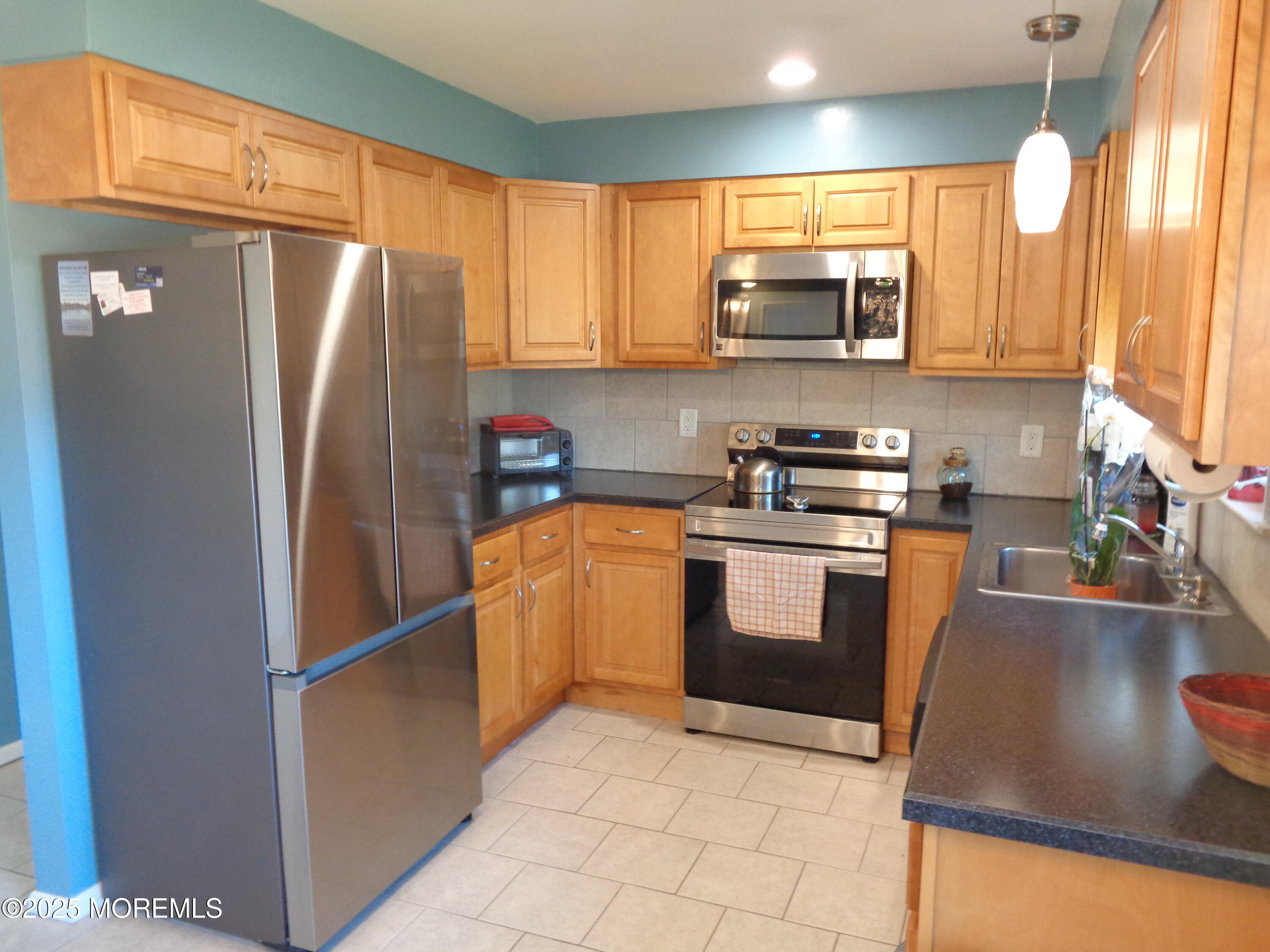 136 A Azalea Drive Whiting, NJ 08759 - Photo 4 of 21 a kitchen with stainless steel appliances granite countertop a refrigerator a stove a sink and a microwave